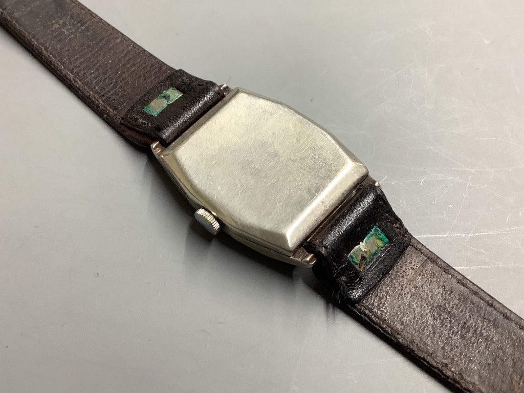 A gentleman's 1930's silver J.W. Benson manual wind wrist watch, on a leather strap.